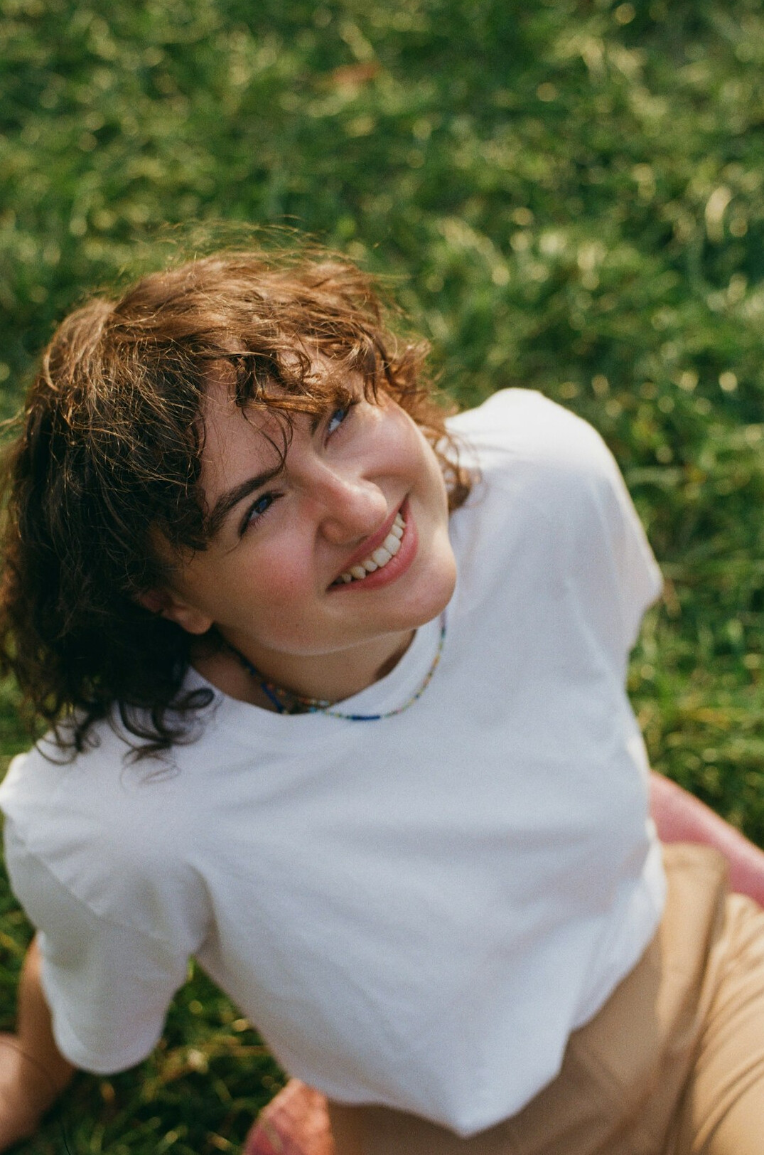 Portrait of a smiling young woman with curly hair