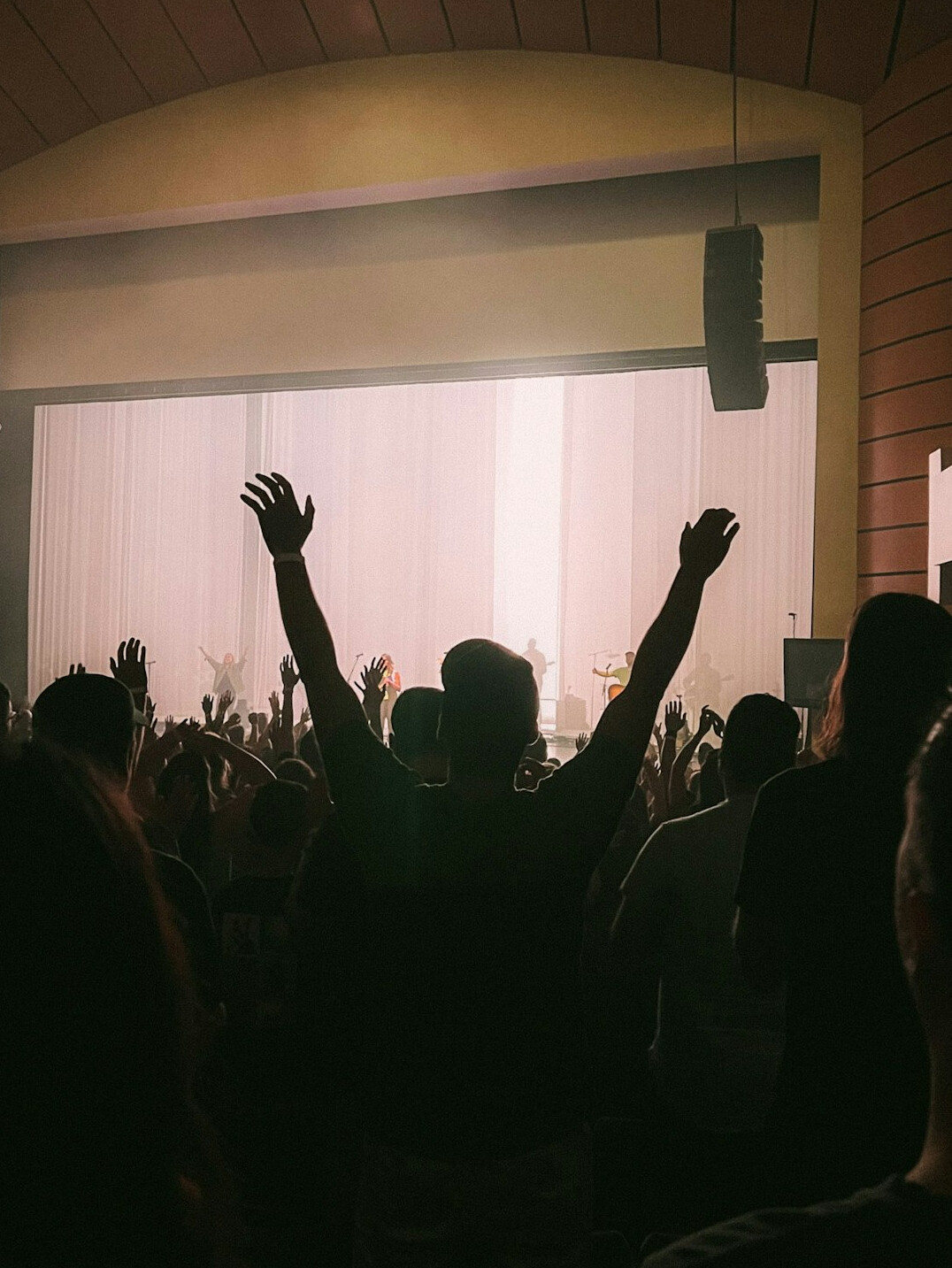 Speaker on stage in front of an audience at a conference