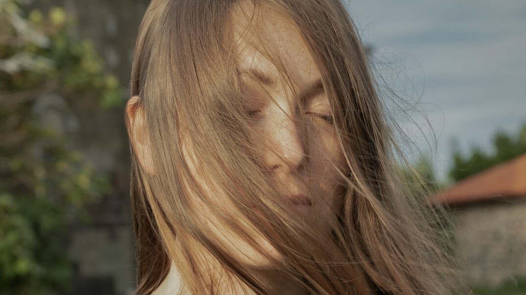 Portrait of a woman with long hair smiling softly